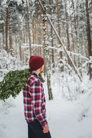 bearded man with pine branches in the winter forestの写真素材
