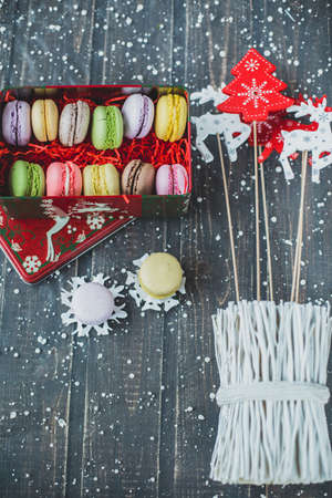 Christmas background with macaroons garlands and snowの写真素材
