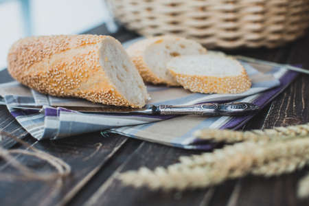 Healthy organic rye and white wheat homemade bread loafs with sesame in basket outdoors for sale.
