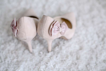 wedding shoes for bride beautiful standing in the backgroundの写真素材