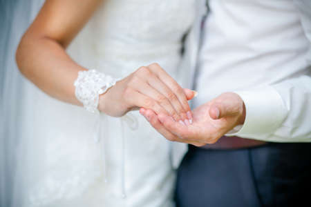 Bride and groom holding handsの写真素材