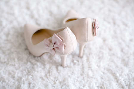 wedding shoes for bride beautiful standing in the backgroundの写真素材