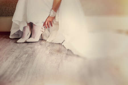 Bride wearing white wedding dress and shoesの写真素材