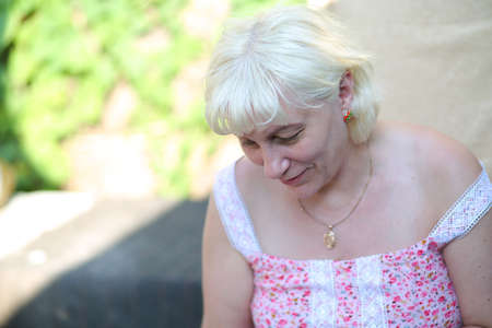 an elderly woman in the garden outdoorsの写真素材