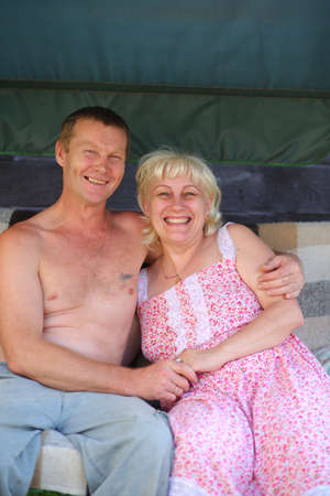 happy adult couple in my garden huggingの写真素材