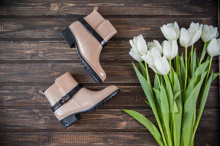 Female shoes with flowers on wooden backgroundの写真素材