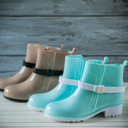 rubber boots on wooden backgroundの写真素材