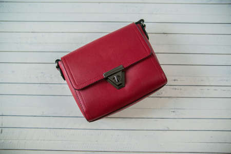 Red glossy female leather bag isolated on white backgroundの写真素材