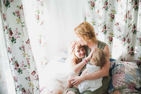 Happy loving family. The mother and two daughtersの写真素材