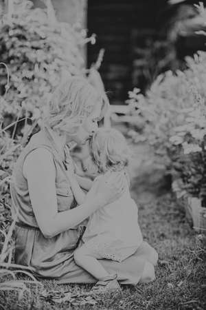 Happy loving family. Mother and daughter on the street embracingの写真素材