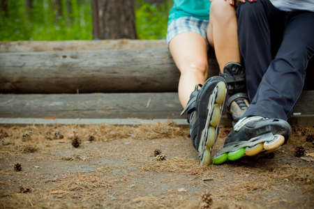 couple sitting in a Park in roller skatesの写真素材