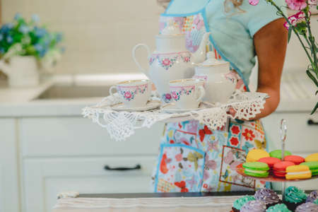Smiling young housewife. Cooking baking in the kitchen at homeの写真素材