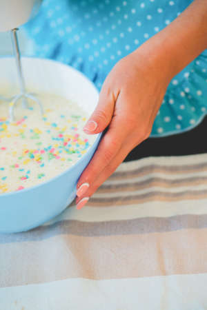 Smiling young housewife. Cooking baking in the kitchen at homeの写真素材