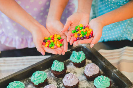 two women in the kitchen preparing food.の写真素材