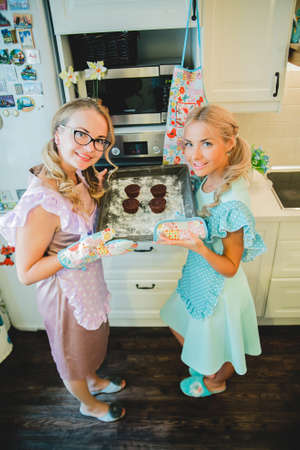 two women in the kitchen preparing food.の写真素材