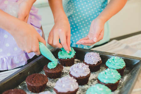 two women in the kitchen preparing food.の写真素材