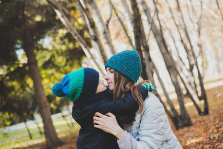 mother and baby playing in autumn Park outdoorsの写真素材