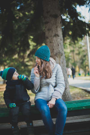 mother and baby playing in autumn Park outdoorsの写真素材