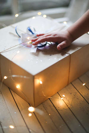 child unties the box with a gift