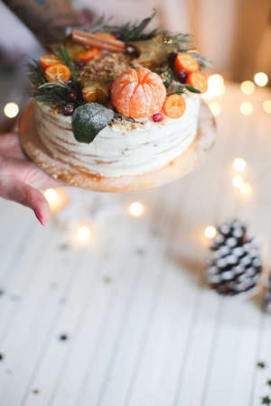 woman puts a christmas cake on a standの写真素材