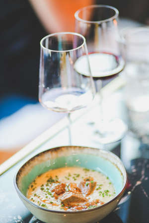 Close-up of food and wine glass on dining table in restaurantの写真素材