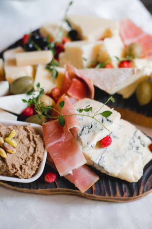 Mix cheese on wooden board with grapes. Top view.の写真素材