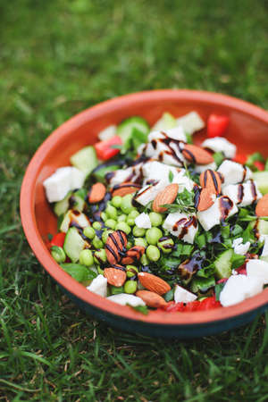 Fresh mixed green salad in a bowl close upの写真素材