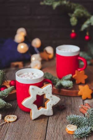 Christmas mug with hot cocoa sparkling bengal fire work lights, and festive decorations. Christmas.tree lights bokeh in the backgroundの写真素材