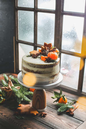 Christmas cake on a window background. Christmas cake stands by the window, which is snowing.の写真素材