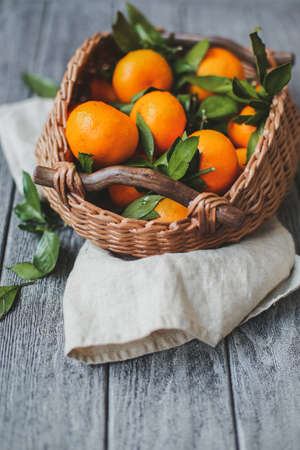 Citrus fruits in basket. Oranges, limes and lemons. Over wooden table background with copy spaceの写真素材