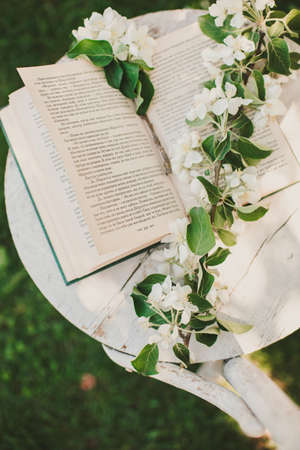 Novosibirsk city, 05/12/2020. composition with a cup of tea with a plaid and a book on a chair on a background of wood. breakfast in natureのeditorial素材