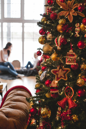 Merry Christmas and Happy Holidays. young mother with daughter on background of christmas tree out...