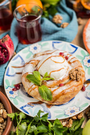 round cake in oriental style with a scoop of ice creamの写真素材