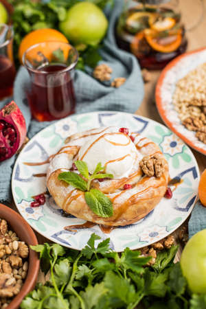 round cake in oriental style with a scoop of ice creamの写真素材