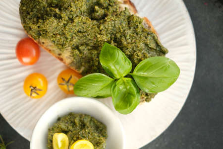 Ciabatta with tomato, mozzarella and rocket salad with pesto sauce.