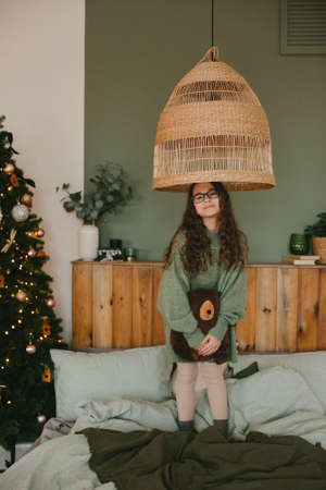 Happy young woman with cute teenage daughter in christmas interior on bed.の写真素材