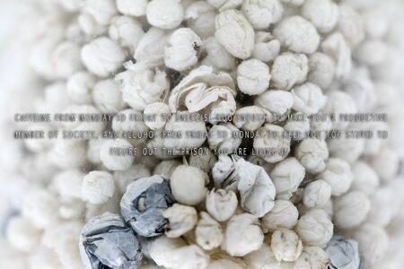 Text quote about caffeine and alcohol in small balls of papers fifty megapixels