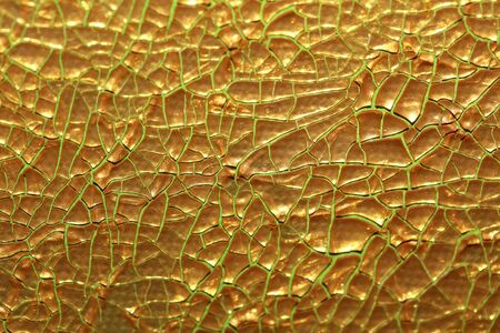 Cracked golden paint on canvas macro background high quality fifty megapixelsの写真素材