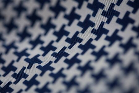 Textile design with black and white crosses macro background high qualityの写真素材