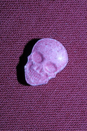 Pink skull ecstasy pill close up background high quality prints purple army dope narcotics substance high dose psychedelic way of lifeの写真素材