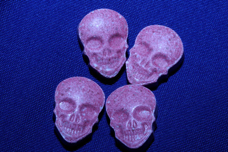 Pink skull ecstasy pill close up background high quality prints purple army dope narcotics substance high dose psychedelic way of lifeの写真素材
