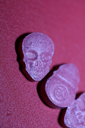 Pink skull ecstasy pill close up background high quality prints purple army dope narcotics substance high dose psychedelic way of lifeの写真素材