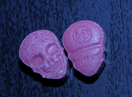 Pink skull ecstasy pill close up background high quality prints purple army dope narcotics substance high dose psychedelic way of lifeの写真素材