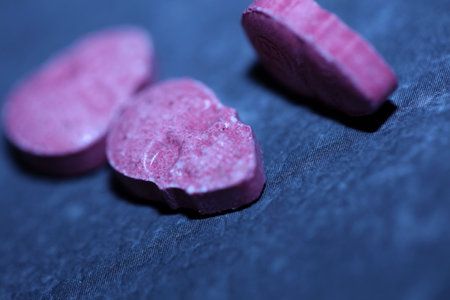 Pink skull ecstasy pill close up background high quality prints purple army dope narcotics substance high dose psychedelic way of lifeの写真素材