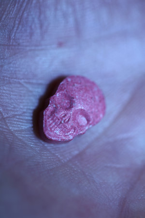 Pink skull ecstasy pill close up background high quality prints purple army dope narcotics substance high dose psychedelic way of lifeの写真素材