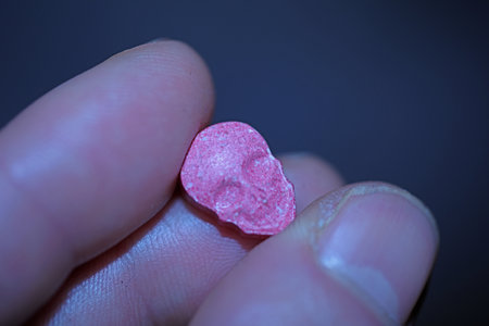 Pink skull ecstasy pill close up background high quality prints purple army dope narcotics substance high dose psychedelic way of lifeの写真素材