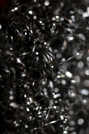 Top view of stainless steel wire mesh kitchen scrubber for scrub cleaning metal sponge clean ball on black background used cleaning stuff macro high quality instant printの写真素材