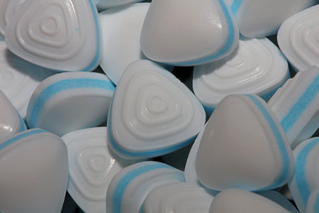 Group of sweet colorful candy light blue triangle refreshment caramel bubble gum close up background modern high quality big size instant stock photography printsの写真素材