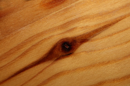 Wooden lacked brown surface macro close abstract texture plate of pine wood with a branch eye knot hole background brown yellow wooden stock photography big size high quality printsの写真素材
