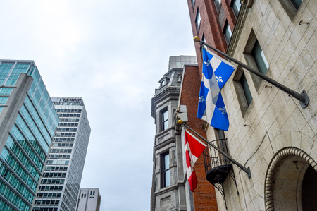 National and Quebec flags on display in Montreal Cityの写真素材